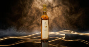 The Nation Pride Indian whisky bottle with golden drink in a glass showcasing premium quality
