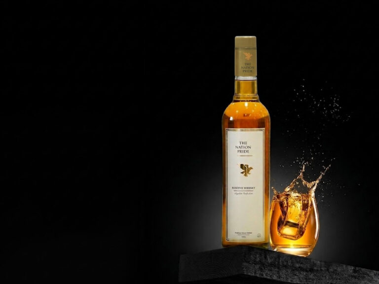 Classic whisky pour from The Nation Pride Whisky bottle into a glass