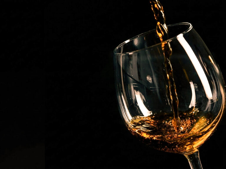 Smooth pour of TheNationPrideWhisky into a crystal whisky glass