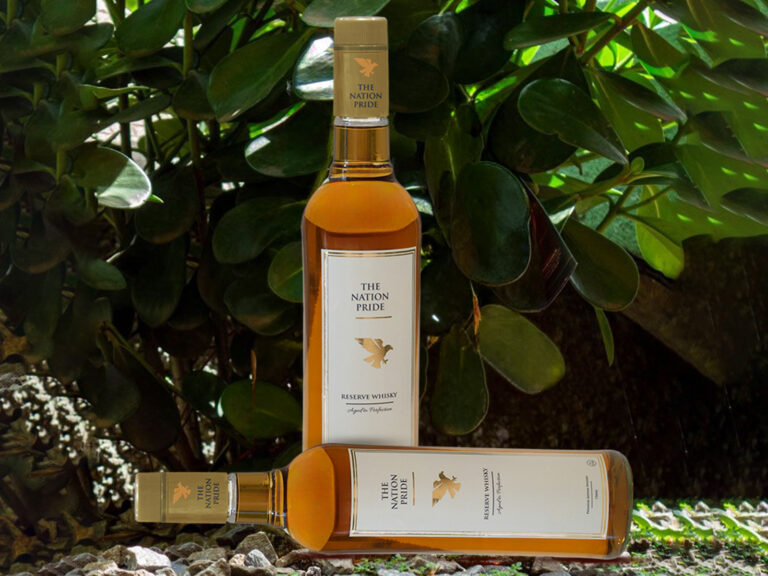 Premium bottle of TheNationPrideWhisky with golden whisky in a glass